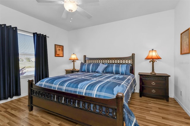 bedroom with ceiling fan and wood-type flooring