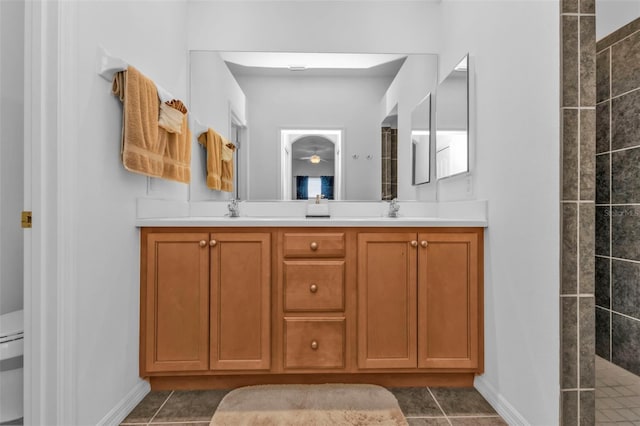 bathroom with a shower, tile patterned floors, and vanity