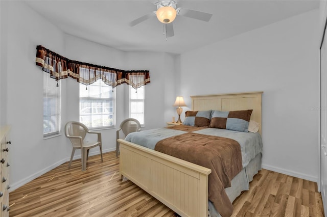 bedroom with ceiling fan and light hardwood / wood-style floors