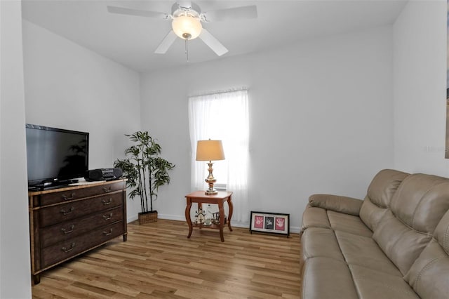 living room with light wood-type flooring and ceiling fan