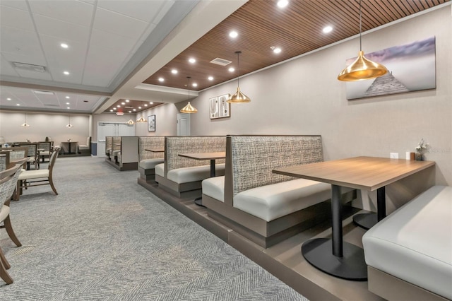 interior space with bar area, carpet flooring, ornamental molding, and wooden ceiling