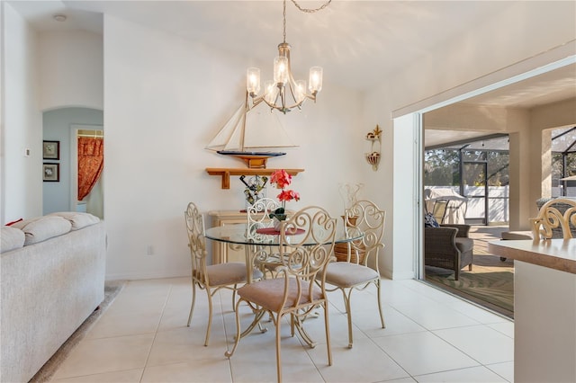 tiled dining room featuring an inviting chandelier