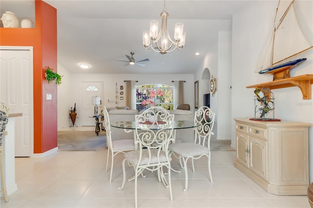 tiled dining space featuring ceiling fan with notable chandelier