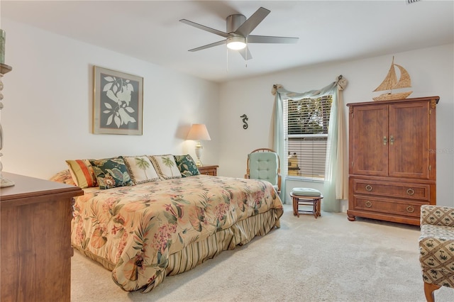 bedroom featuring ceiling fan and light carpet