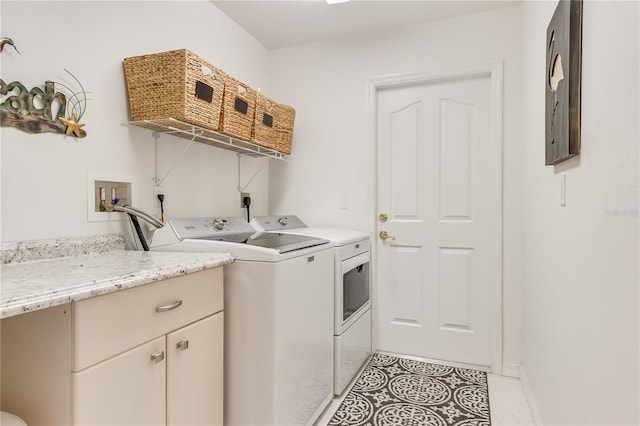 laundry room featuring washing machine and dryer and light tile patterned floors