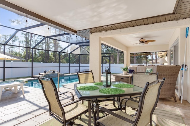 view of patio / terrace with ceiling fan, a lanai, and a fenced in pool