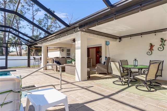 sunroom / solarium featuring ceiling fan and a swimming pool