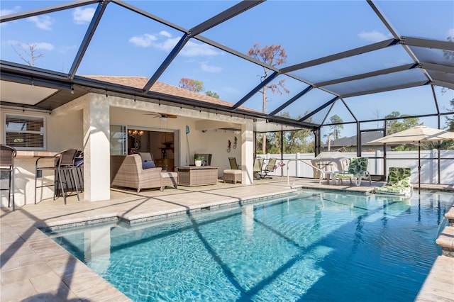 view of swimming pool with an outdoor hangout area, an outdoor bar, ceiling fan, a lanai, and a patio area