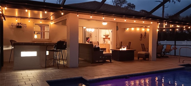 exterior space with an outdoor bar and a patio