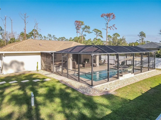 view of swimming pool with a lawn, glass enclosure, outdoor lounge area, and a patio