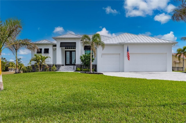 view of front of home with french doors, a garage, and a front yard