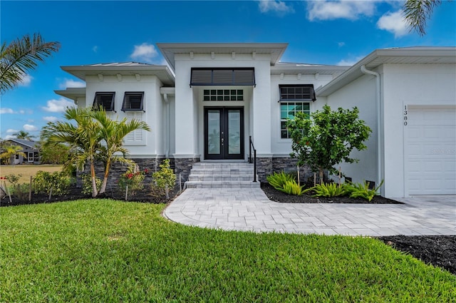 property entrance with a yard and french doors