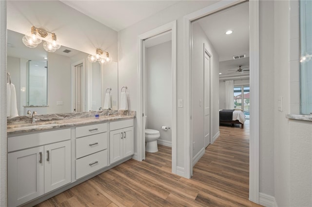 bathroom featuring vanity, toilet, and hardwood / wood-style floors