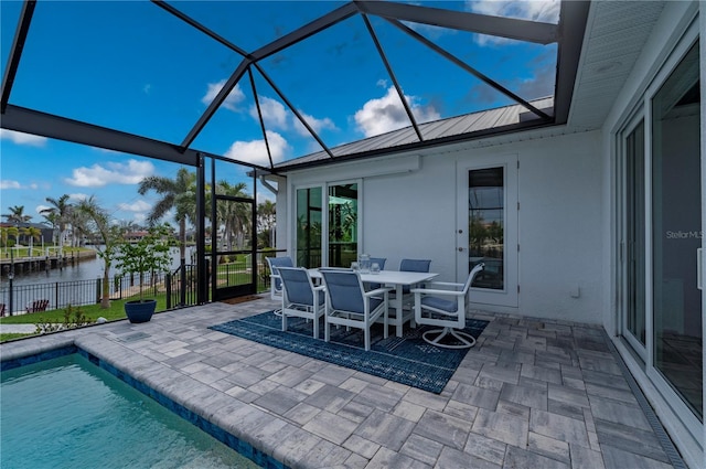 view of patio featuring a fenced in pool, a water view, and a lanai