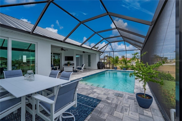 view of swimming pool with a patio, a lanai, and ceiling fan