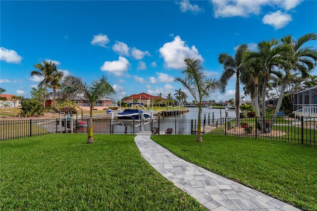 view of yard featuring a water view and a boat dock