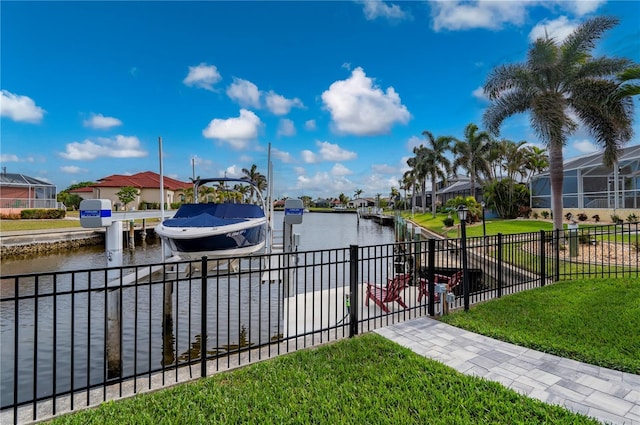 view of dock featuring a water view and a lawn