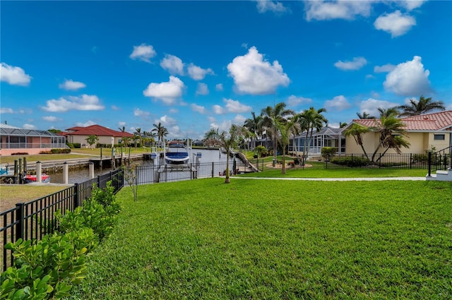 view of yard with a dock and a water view