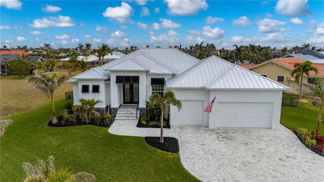 view of front of property with a garage and a front yard