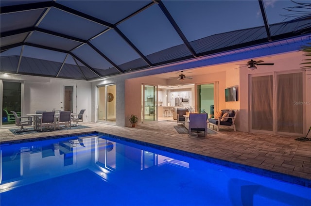 view of swimming pool with a lanai, ceiling fan, and a patio area