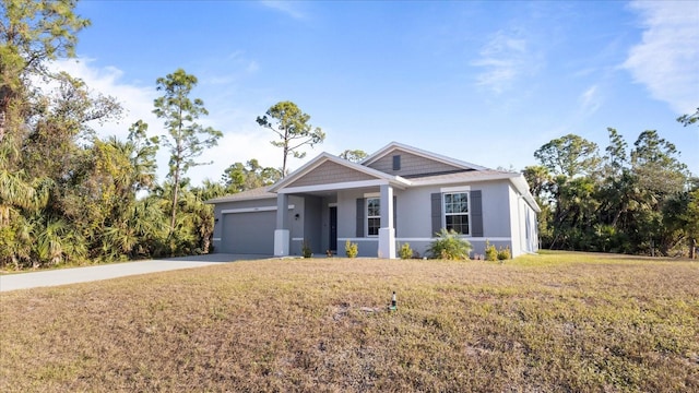 view of front of property with a front yard and a garage