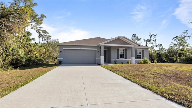 view of front of home with a garage and a front lawn