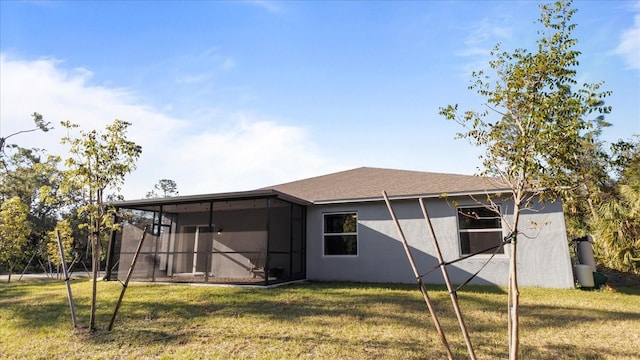 2784 Dode Ave, North Port, FL 34288 - back of property with a sunroom, stucco siding, and a yard