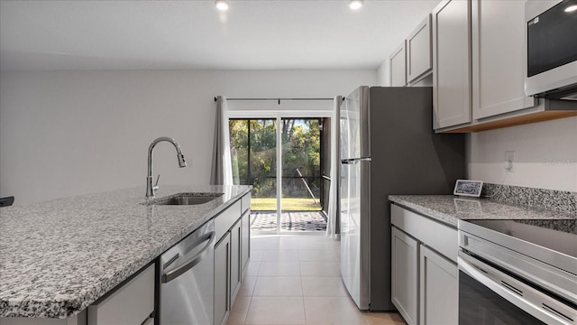 2784 Dode Ave, North Port, FL 34288 - kitchen with appliances with stainless steel finishes, light stone countertops, gray cabinets, light tile patterned flooring, and recessed lighting
