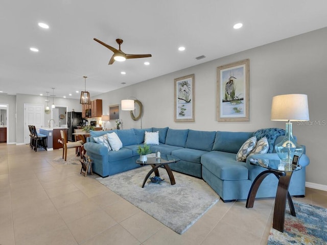 tiled living room featuring ceiling fan