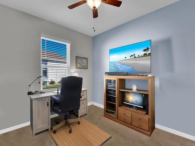 carpeted office featuring ceiling fan