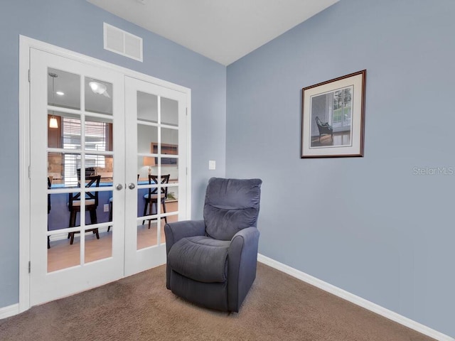 sitting room with carpet and french doors