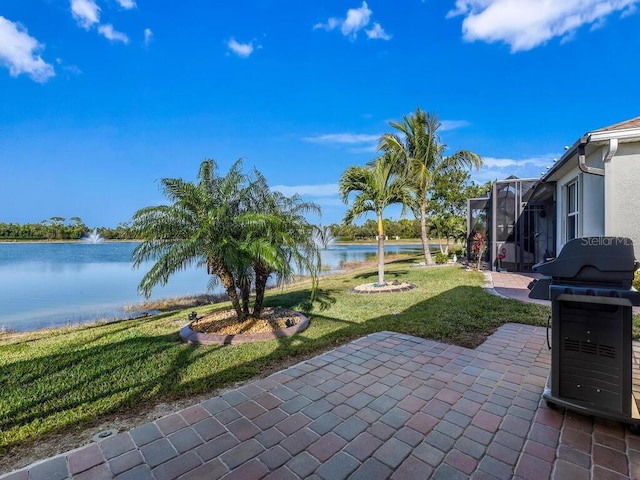 view of patio / terrace with glass enclosure and a water view