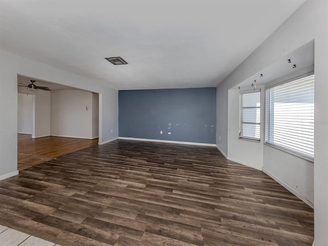 unfurnished room featuring dark hardwood / wood-style floors and ceiling fan