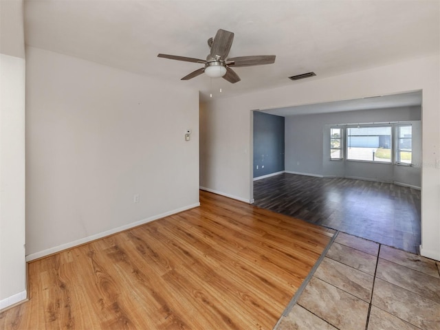 spare room with hardwood / wood-style floors and ceiling fan