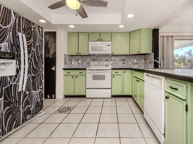 kitchen featuring green cabinets, white appliances, and a tray ceiling