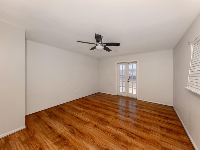 spare room featuring french doors, ceiling fan, and hardwood / wood-style floors