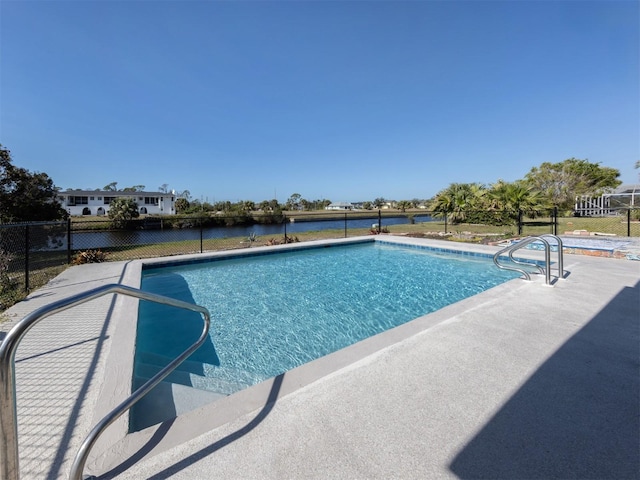 view of pool featuring a water view and a patio