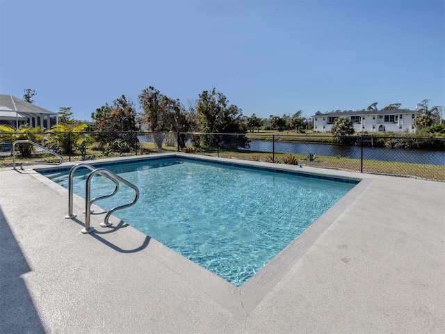 view of pool featuring a patio and a water view