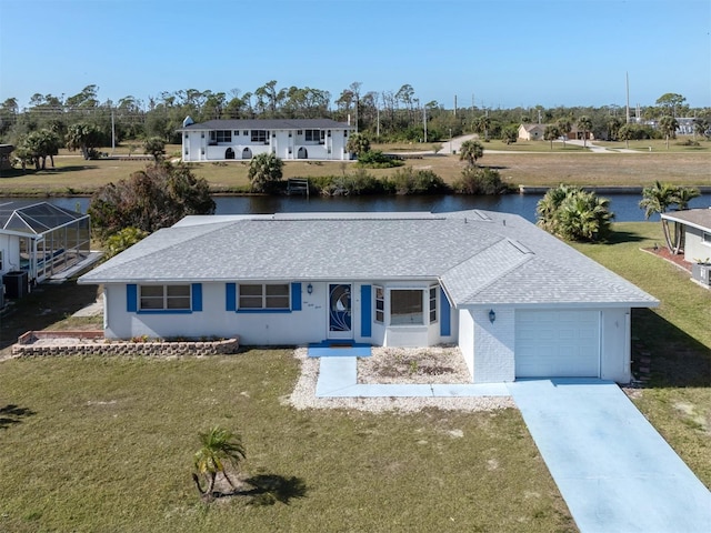 view of front of house with a water view, a garage, and a front lawn