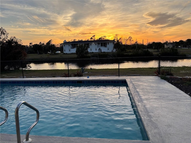 pool at dusk with a water view