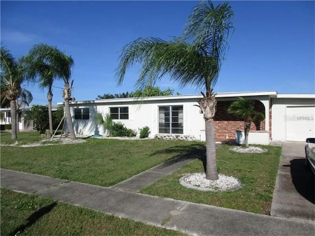 single story home featuring a garage and a front lawn