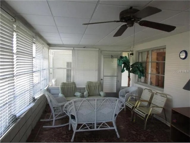 sunroom / solarium featuring ceiling fan and a drop ceiling