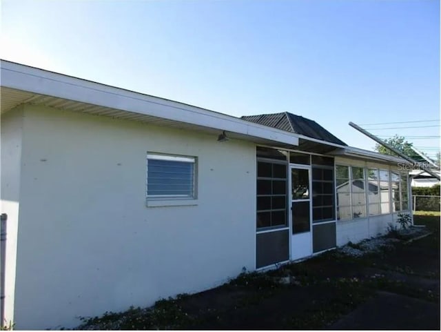 view of side of home with a sunroom