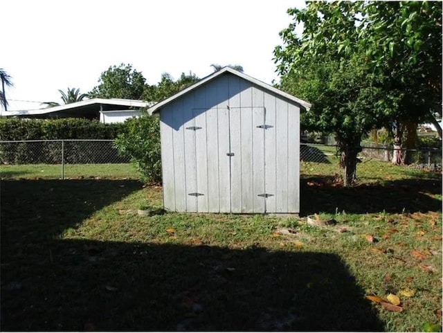 view of outbuilding featuring a lawn