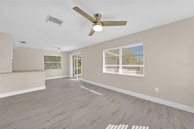 unfurnished room with light hardwood / wood-style flooring and ceiling fan