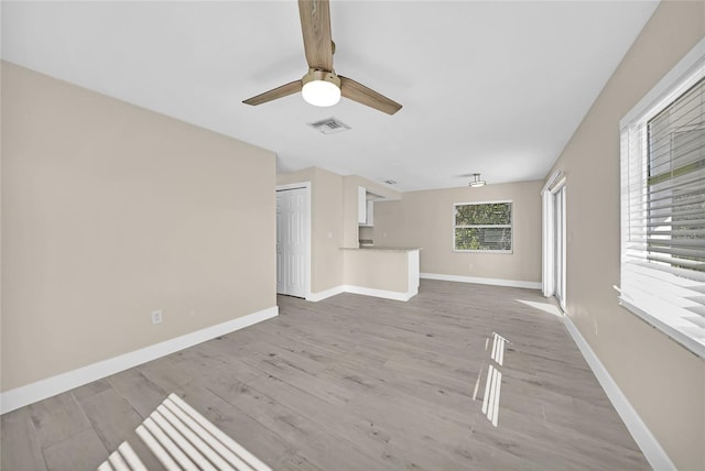 unfurnished living room featuring light hardwood / wood-style floors and ceiling fan