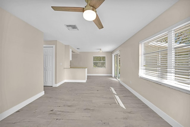 unfurnished living room with ceiling fan and light hardwood / wood-style flooring