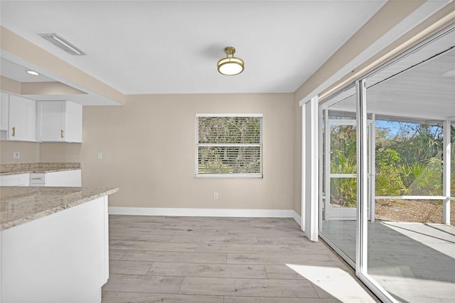 unfurnished dining area with light hardwood / wood-style flooring