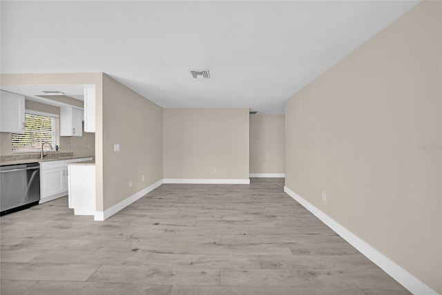 unfurnished living room with sink and light wood-type flooring