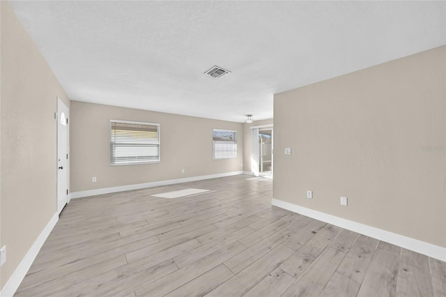 unfurnished room with light wood-type flooring